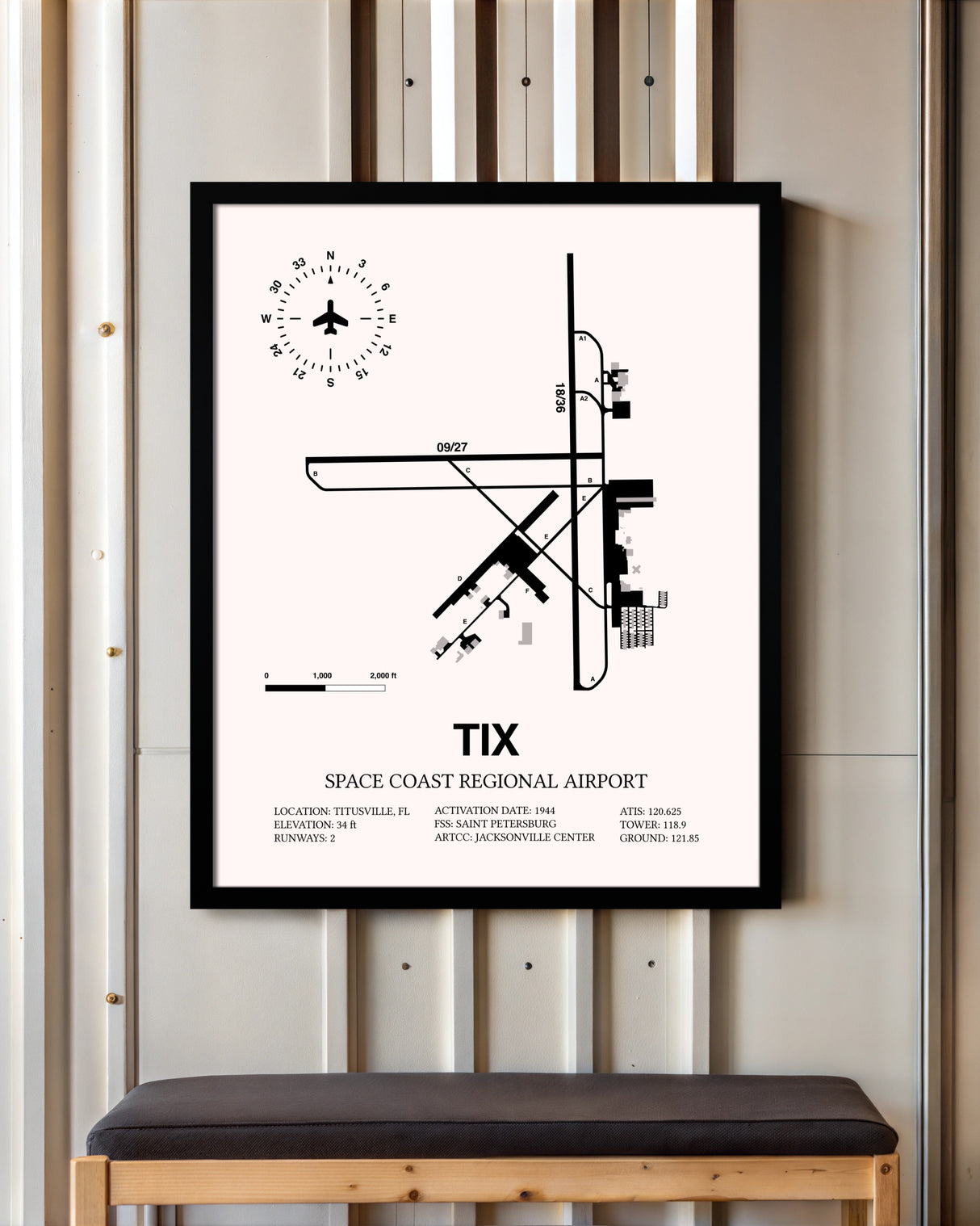 Space Coast Regional Airport framed poster displayed in an airplane hangar