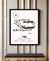 Miami Executive Airport framed poster displayed in an airplane hangar