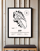 St. Paul Downtown Airport Holman Field framed poster displayed in an airplane hangar