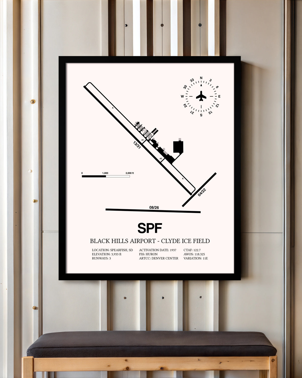 Black Hills Airport-Clyde Ice Field framed poster displayed in an airplane hangar