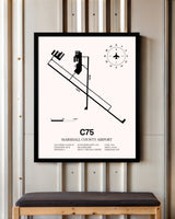 Marshall County Airport framed poster displayed in an airplane hangar