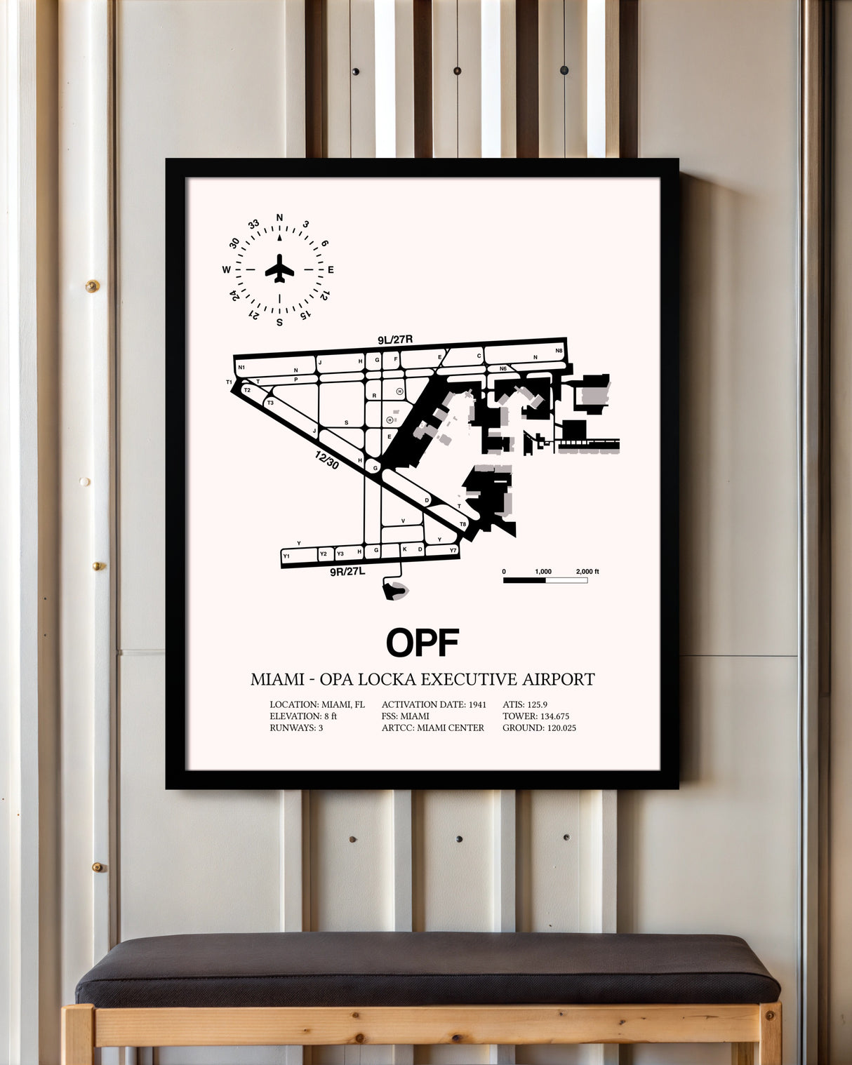 Miami-Opa Locka Executive Airport framed poster displayed in an airplane hangar