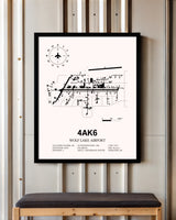 Wolf Lake Airport framed poster displayed in an airplane hangar