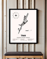 Deerfield Resort Airport framed poster displayed in an airplane hangar
