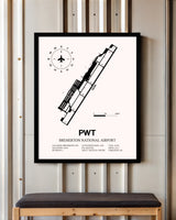 Bremerton National Airport framed poster displayed in an airplane hangar