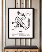 Crystal Airport framed poster displayed in an airplane hangar