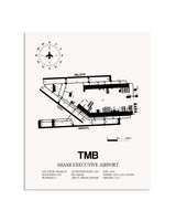 Gray Miami Executive Airport framed poster displayed in an airplane hangar