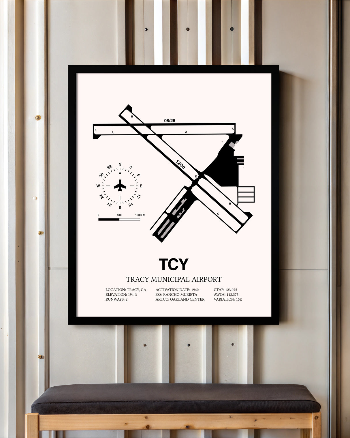 Tracy Municipal Airport framed poster displayed in an airplane hangar