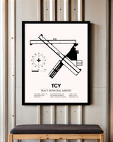Tracy Municipal Airport framed poster displayed in an airplane hangar