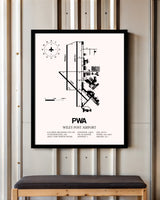 Wiley Post Airport framed poster displayed in an airplane hangar