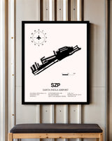 Santa Paula Airport framed poster displayed in an airplane hangar