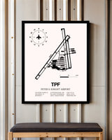 Peter O. Knight Airport framed poster displayed in an airplane hangar