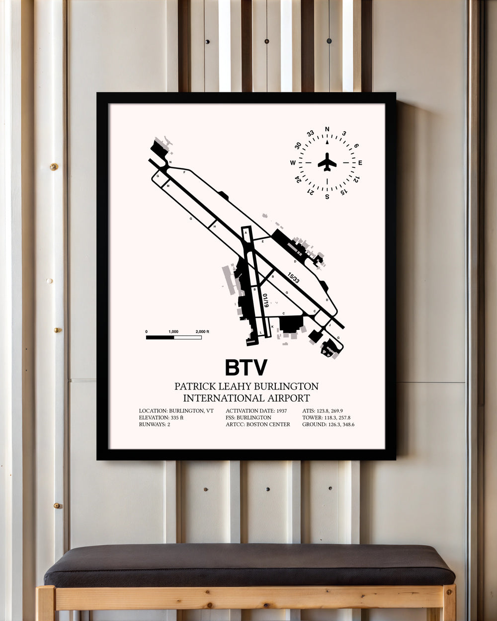 Patrick Leahy Burlington International Airport framed poster displayed in an airplane hangar