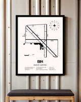 Bishop Airport framed poster displayed in an airplane hangar