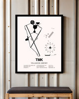 Tillamook Airport framed poster displayed in an airplane hangar