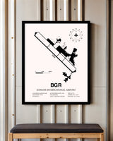 Bangor International Airport framed poster displayed in an airplane hangar