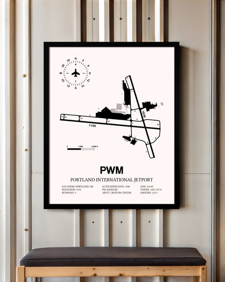 Portland International Jetport framed poster displayed in an airplane hangar