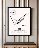 Laurel Municipal Airport framed poster displayed in an airplane hangar