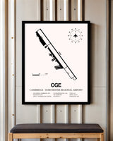 Cambridge-Dorchester Regional Airport framed poster displayed in an airplane hangar