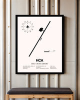 Holy Cross Airport framed poster displayed in an airplane hangar