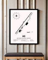 Richard Downing Airport framed poster displayed in an airplane hangar
