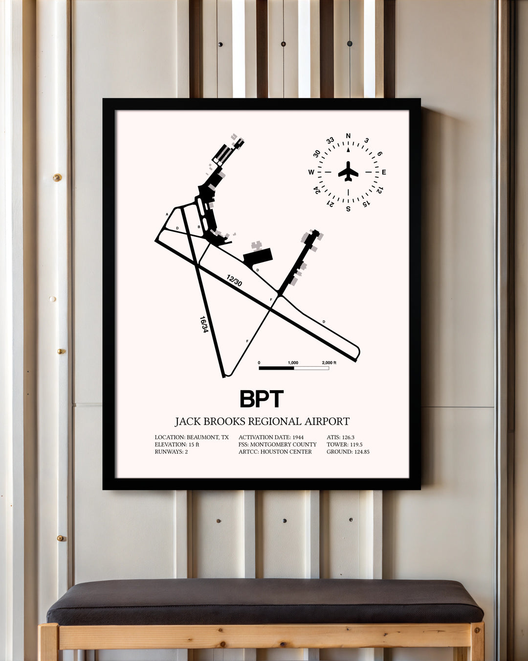 Jack Brooks Regional Airport framed poster displayed in an airplane hangar
