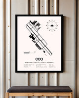 Newnan Coweta County Airport framed poster displayed in an airplane hangar
