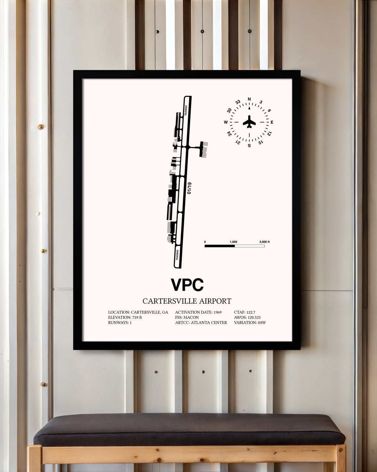 Cartersville Airport framed poster displayed in an airplane hangar