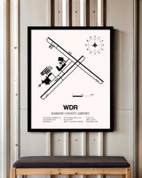 Barrow County Airport framed poster displayed in an airplane hangar