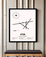 Harman Airport framed poster displayed in an airplane hangar