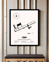 Orange County Airport framed poster displayed in an airplane hangar