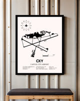 Capital City Airport framed poster displayed in an airplane hangar