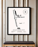 Red Bluff Municipal Airport framed poster displayed in an airplane hangar