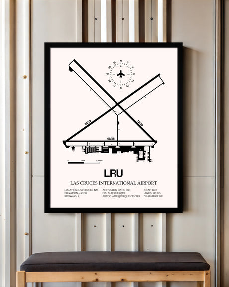 Las Cruces International Airport framed poster displayed in an airplane hangar
