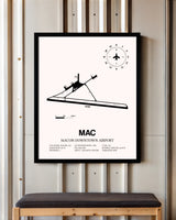 Macon Downtown Airport framed poster displayed in an airplane hangar