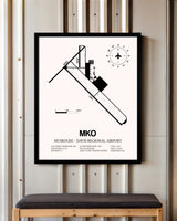 Muskogee-Davis Regional Airport framed poster displayed in an airplane hangar
