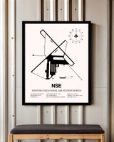 Whiting Field Naval Air Station North framed poster displayed in an airplane hangar