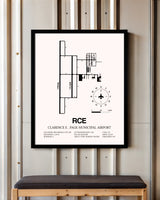 Clarence E. Page Municipal Airport framed poster displayed in an airplane hangar