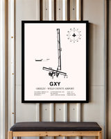Greeley-Weld County Airport framed poster displayed in an airplane hangar